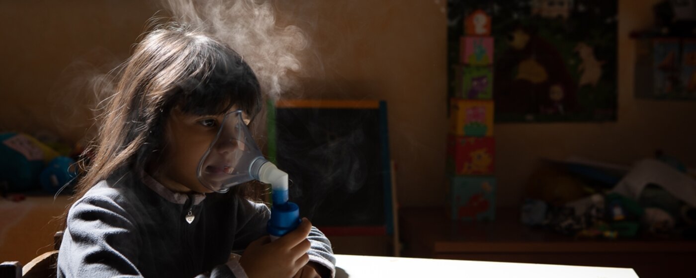 Girl using an inhaler.