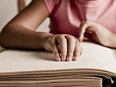 Child reading braille