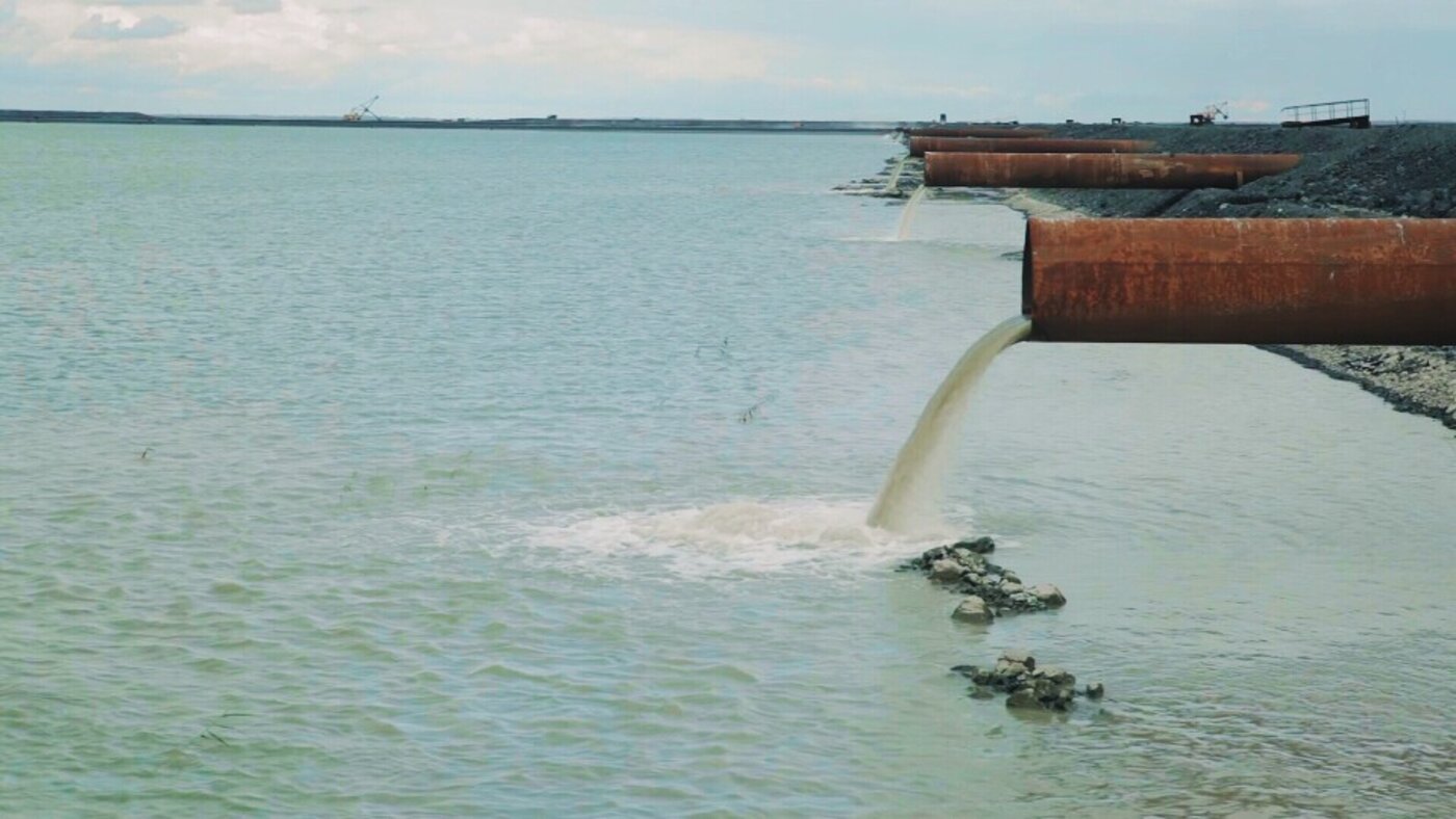 Large pipes draining wastewater into river