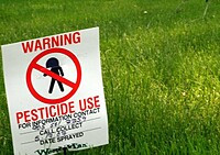 Pesticide use warning sign on lawn